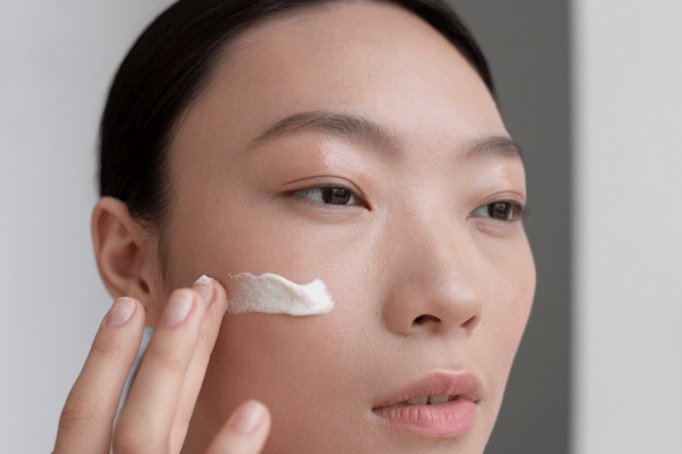 A person applying a cream on her face
AI-generated content may be incorrect.